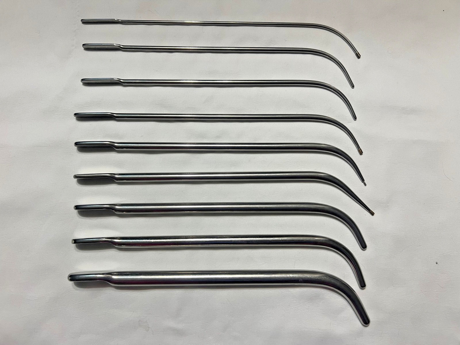 Set Of 9 V. Mueller Van Buren & Lefort Urethral Sound Dilators Curved 10-5/8″ L